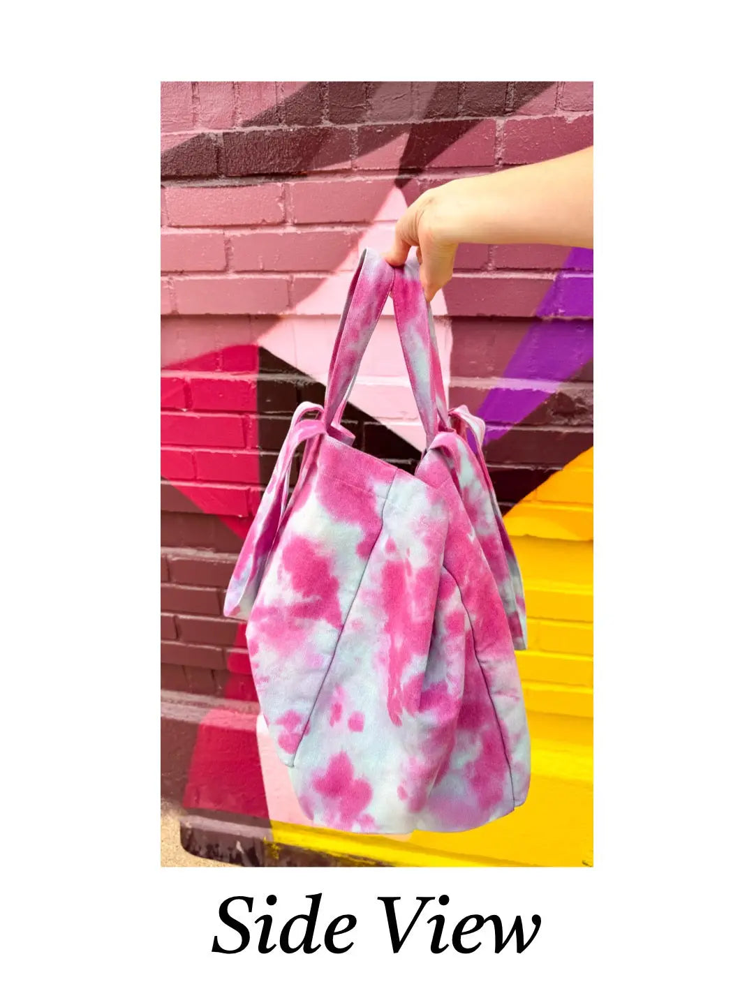 Tie-dye bag held by a hand with a colorful background